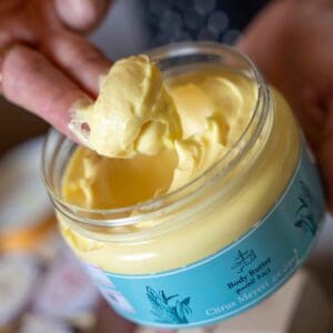 Naturally luxurious, fragrant and handmade skincare Body Butter by House of Soap being scooped out by hand